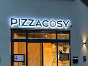 Devanture du restaurant Pizza Cosy à Lyon, son enseigne lumineuse au-dessus de l’entrée